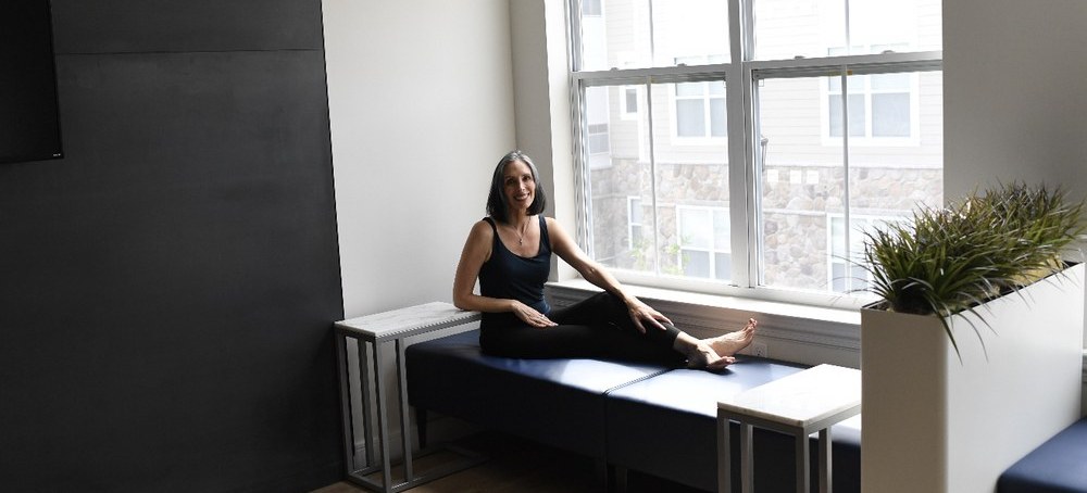 Gina Santangelo by the windows at the GLOW Body studio in Ridgewood, NJ